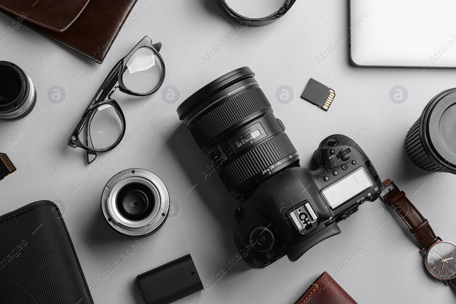 Photo of Flat lay composition with professional photographer equipment on light background