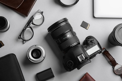 Flat lay composition with professional photographer equipment on light background