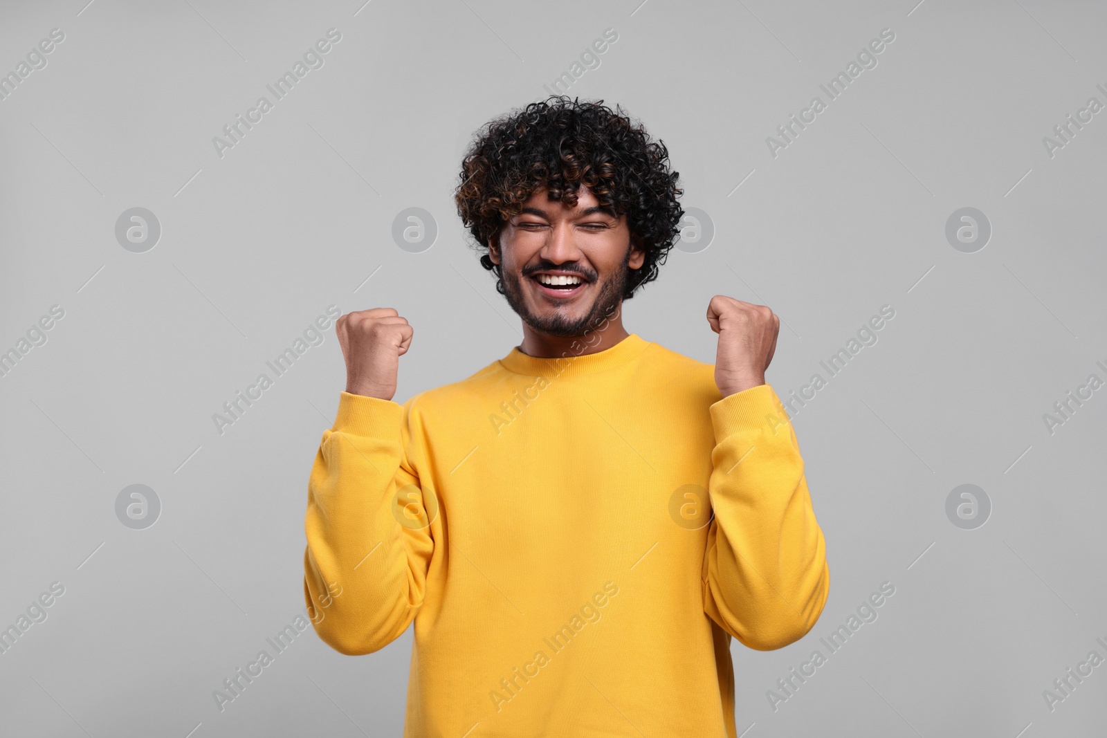 Photo of Handsome young man on light grey background