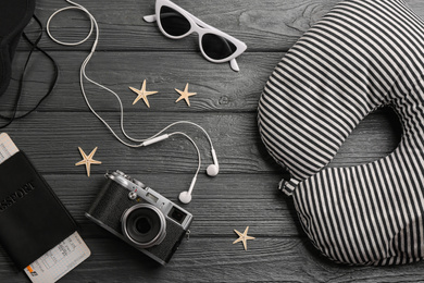 Flat lay composition with striped travel pillow on wooden background