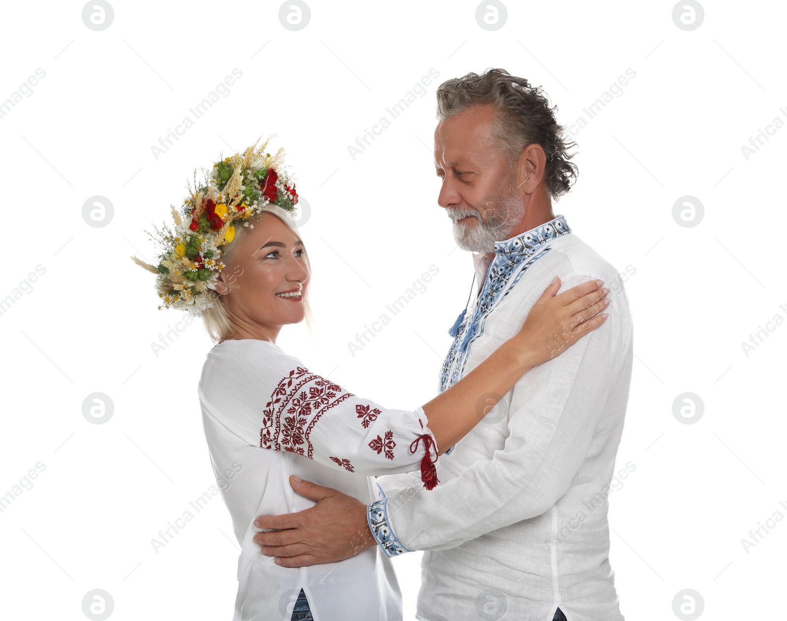 Photo of Happy mature couple in Ukrainian national clothes on white background