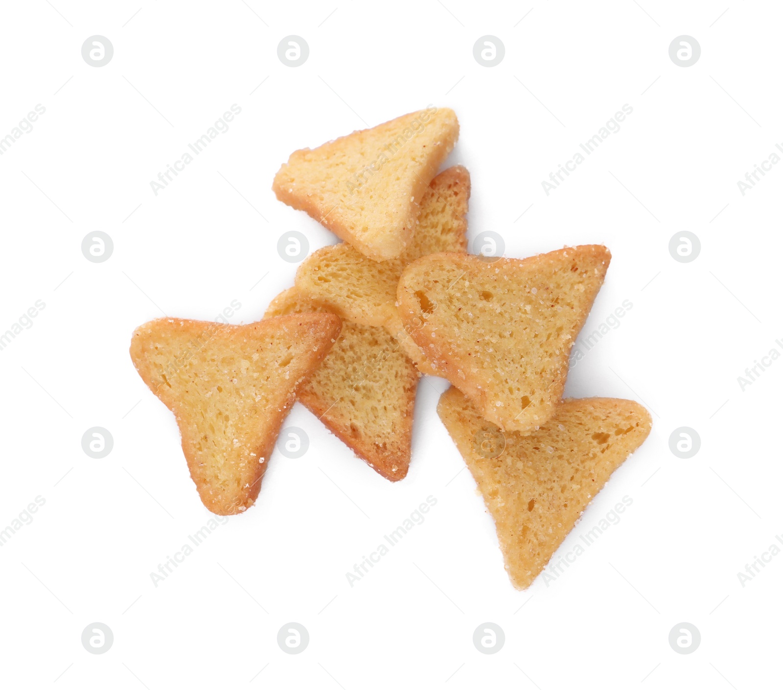 Photo of Pile of delicious crispy rusks on white background, top view