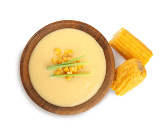 Delicious corn cream soup and cobs on white background, top view