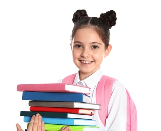 Happy girl in school uniform with stack of books on white background