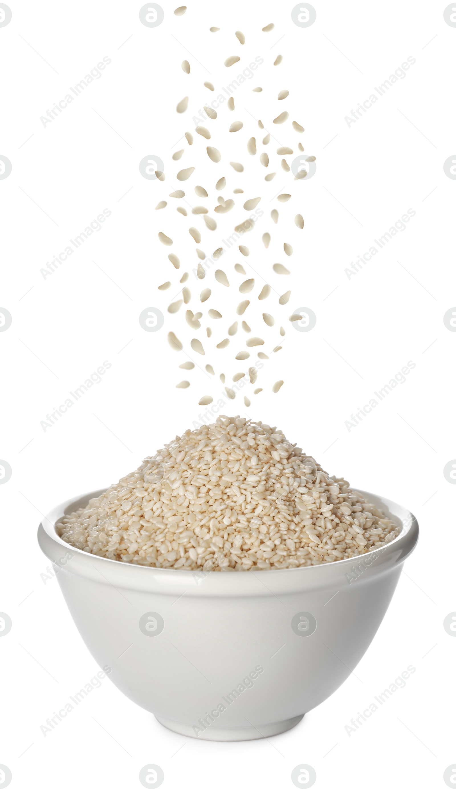 Image of Sesame seeds falling into bowl on white background 