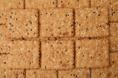 Photo of Cereal crackers with flax and sesame seeds as background, top view