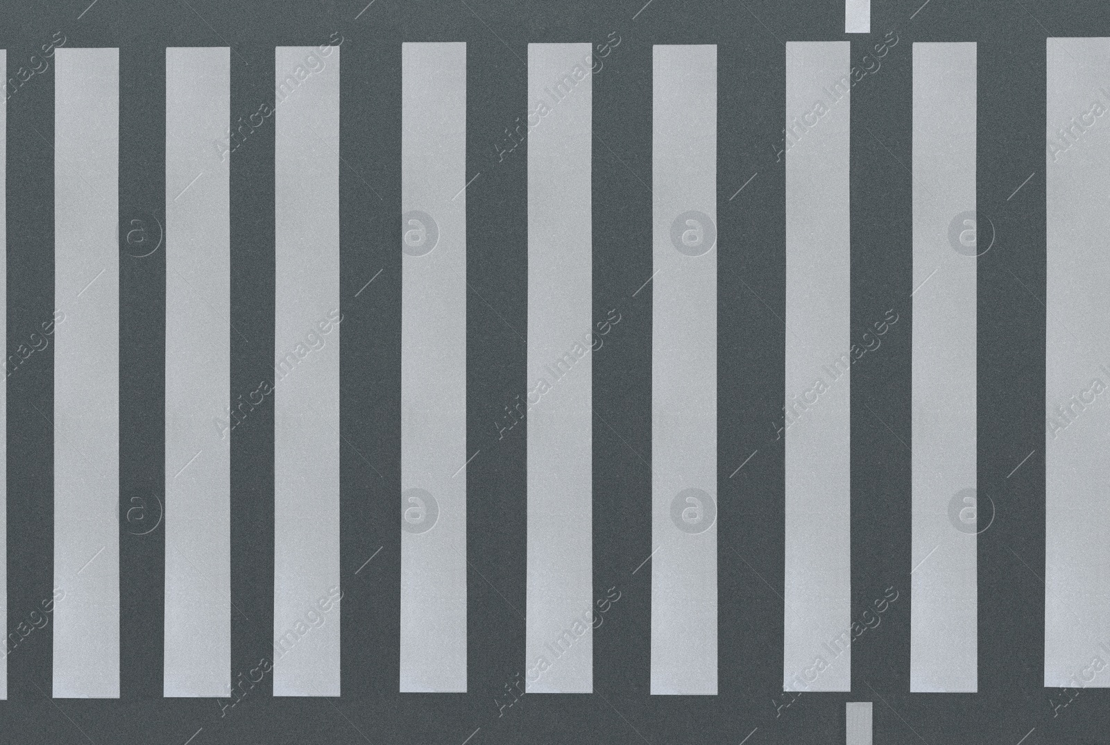 Image of White pedestrian crossing on empty city street, top view