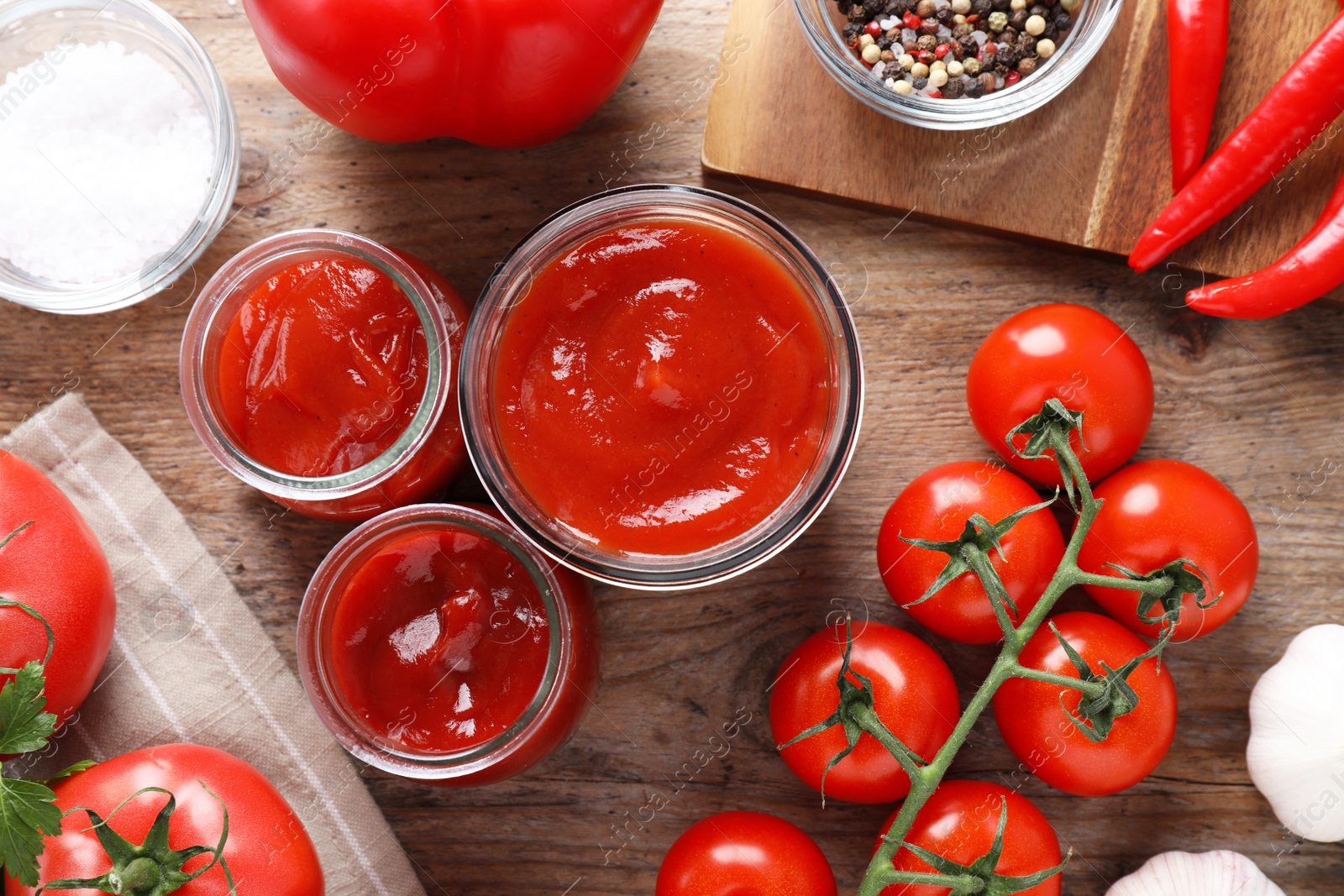 Photo of Flat lay composition with tomato sauce on wooden table