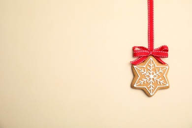 Photo of Tasty homemade Christmas cookie on color background