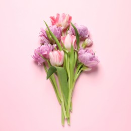 Photo of Beautiful colorful tulip flowers on pink background, top view