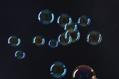 Beautiful transparent soap bubbles on dark background