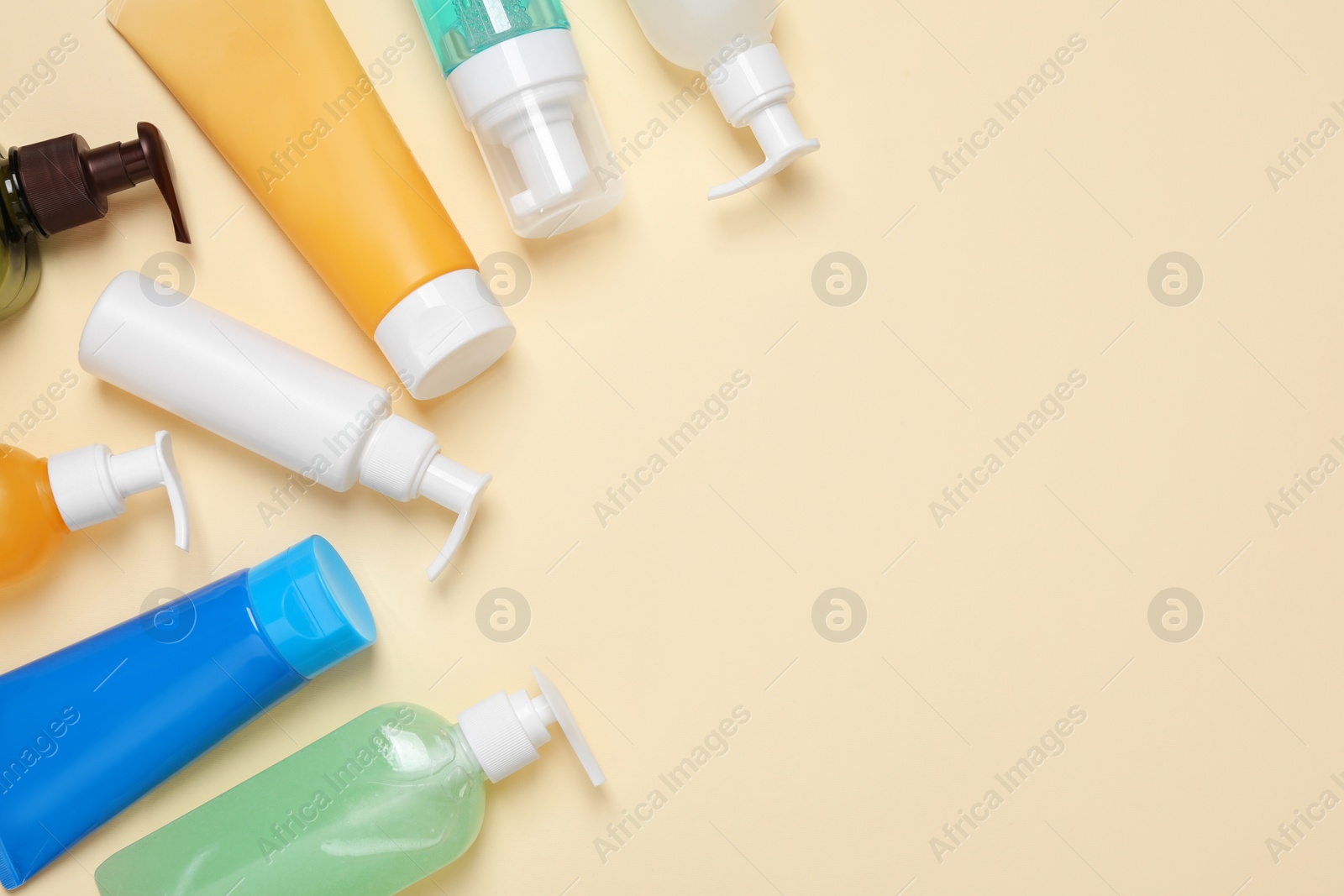 Photo of Different cleansers on beige background, flat lay with space for text. Cosmetic product