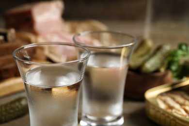 Photo of Cold traditional Russian vodka on table, closeup view