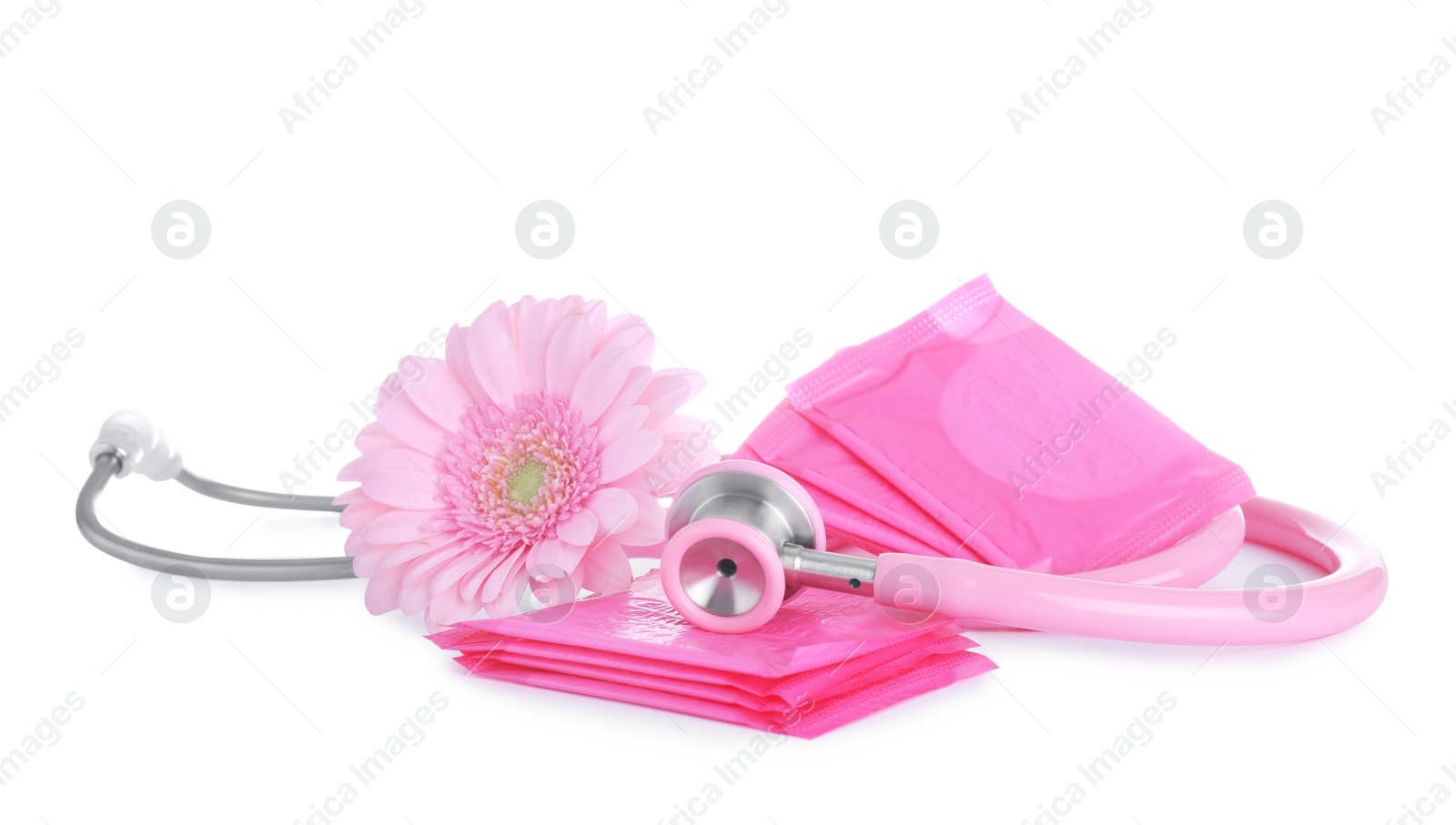 Photo of Stethoscope, menstrual pads and flower on white background. Gynecology concept