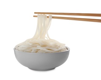 Photo of Taking rice noodles with chopsticks from bowl on white background