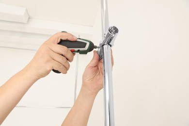 Photo of Worker installing new metal pipes with electric drill, closeup