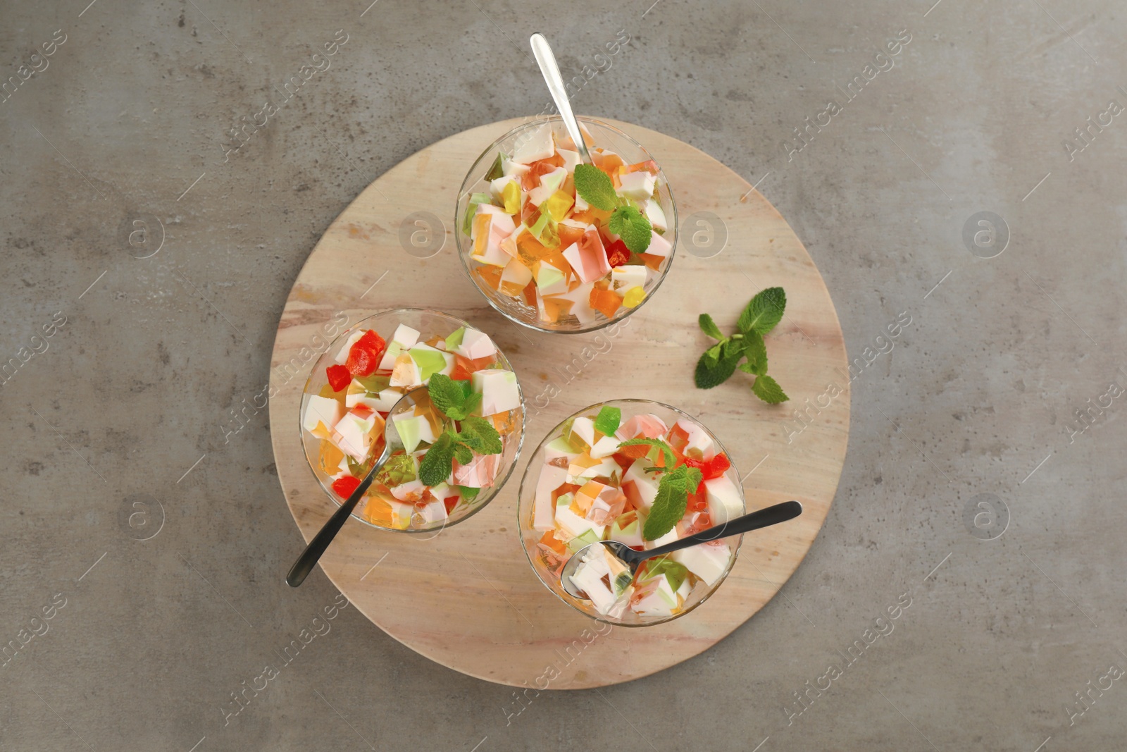 Photo of Delicious broken glass jelly dessert on grey table, top view