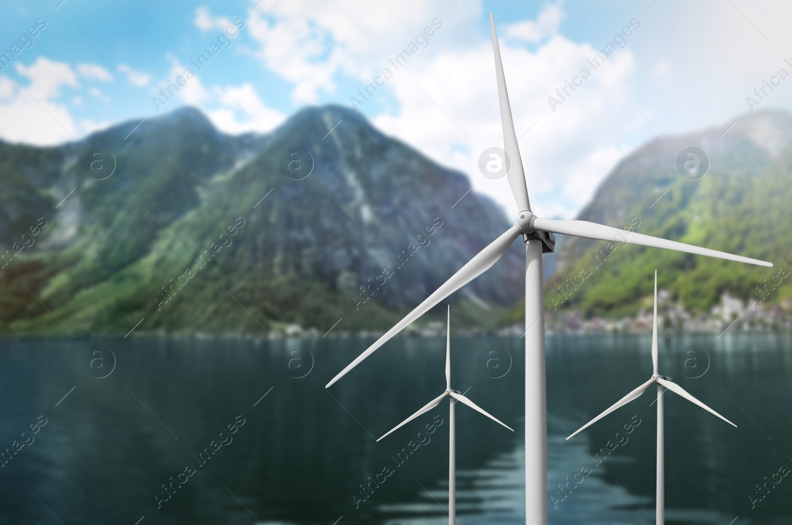 Image of Alternative energy source. Wind turbines near mountains