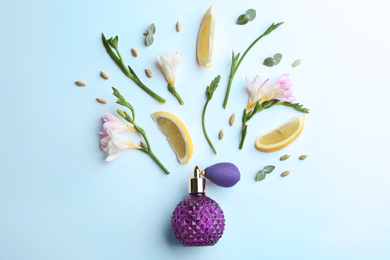 Photo of Beautiful composition with bottle of perfume, lemon and flowers on white background, flat lay
