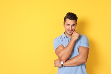 Photo of Portrait of handsome young man and space for text on color background