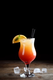 Photo of Just made appetizing cocktail Sex on the Beach, black background