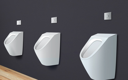 Image of Clean ceramic urinals in men's public bathroom