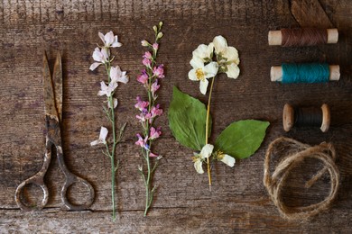 Photo of Flat lay composition with beautiful dried flowers on wooden table