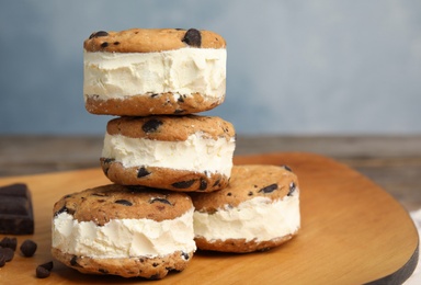 Photo of Sweet delicious ice cream cookie sandwiches on table, space for text