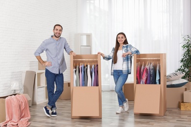 Young couple near wardrobe boxes at home
