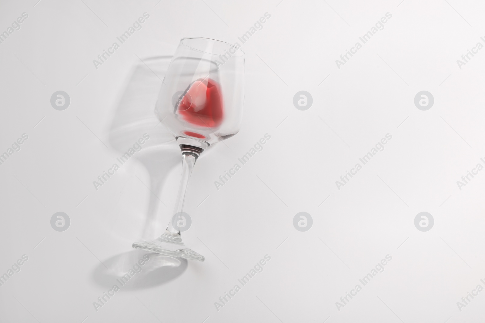 Photo of Tasty red wine in glass isolated on white, top view