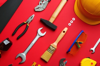 Photo of Flat lay composition with construction tools on color background