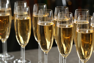 Photo of Many glasses of champagne on blurred background, closeup