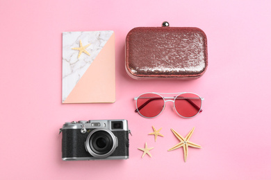 Flat lay composition with camera for professional photographer on pink background