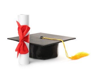 Photo of Graduation hat and diploma on white background