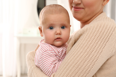 Photo of Young woman and her little baby at home, closeup