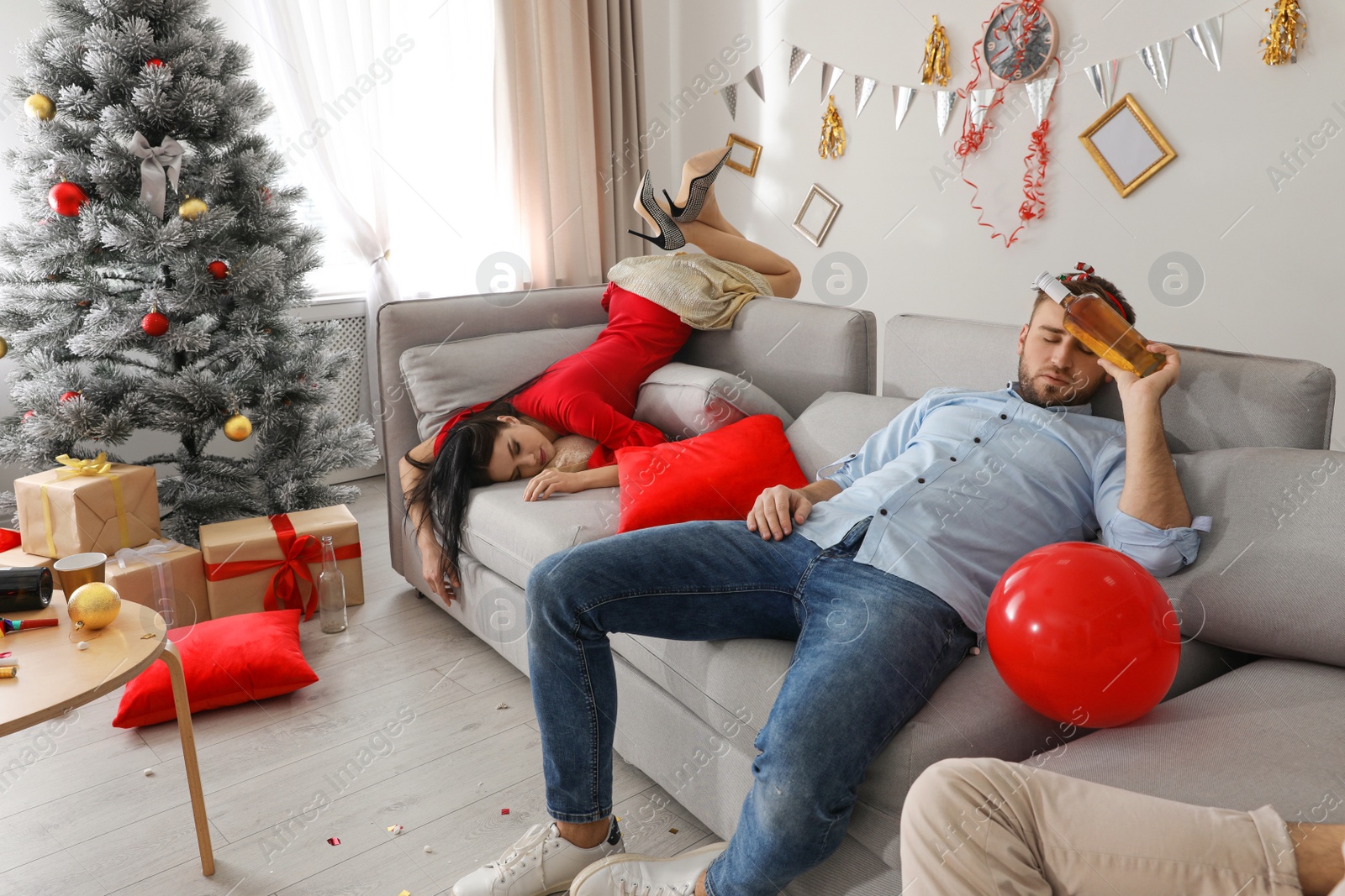 Photo of Drunk friends sleeping in messy room after New Year party