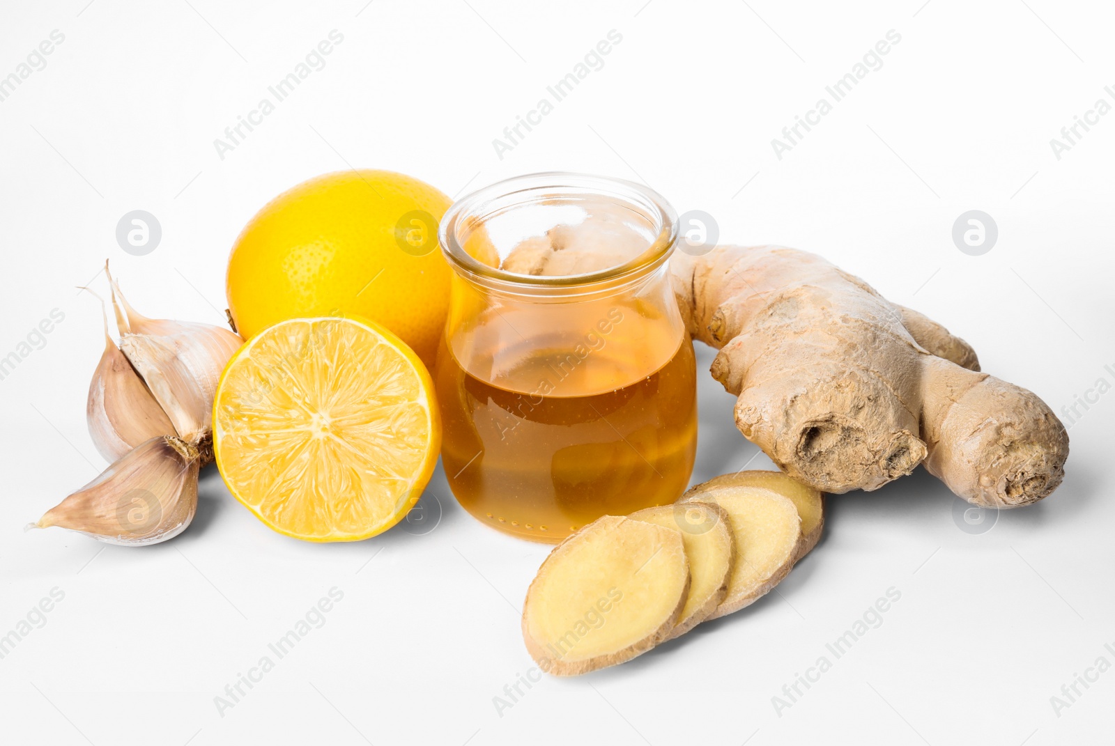 Photo of Fresh garlic and other natural cold remedies isolated on white