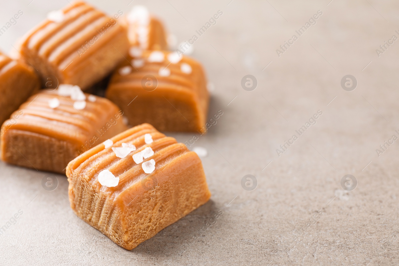 Photo of Salted caramel on light grey table, closeup. Space for text