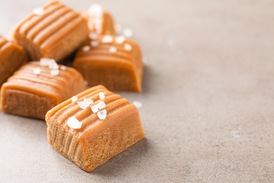 Photo of Salted caramel on light grey table, closeup. Space for text