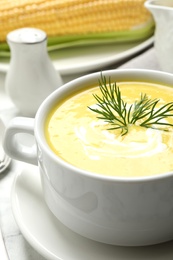 Delicious creamy corn soup on table, closeup