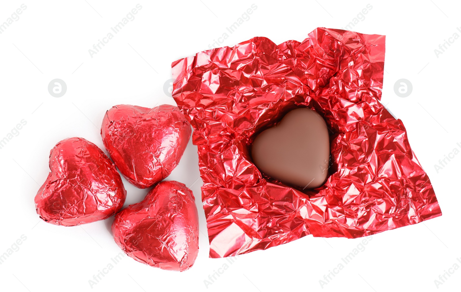Photo of Heart shaped chocolate candies on white background, top view