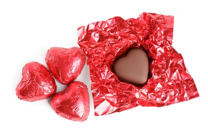 Heart shaped chocolate candies on white background, top view