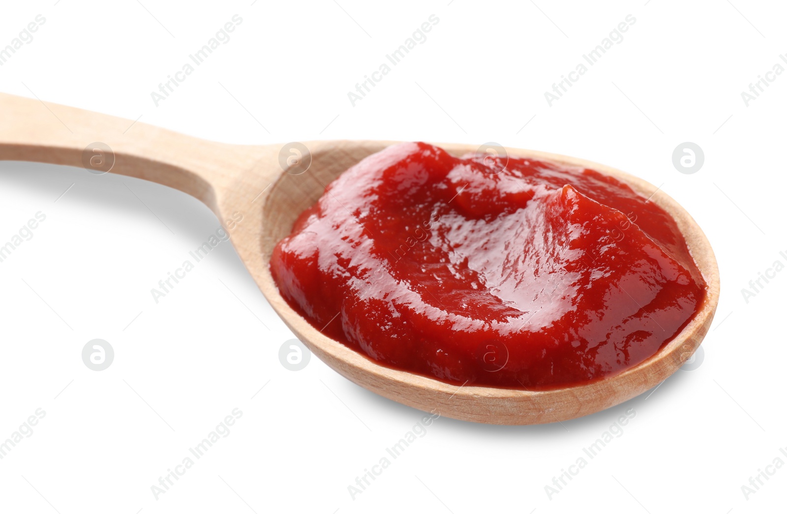 Photo of Tasty ketchup in wooden spoon isolated on white, closeup