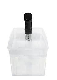 Photo of Thermal immersion circulator in plastic container with water isolated on white. Sous vide cooker