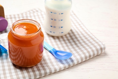 Healthy baby food in jar on table. Space for text