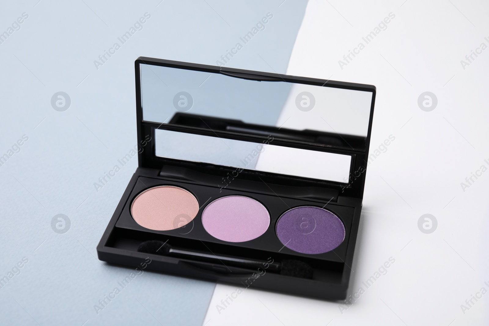 Photo of Eye shadow palette on colorful background, closeup. Product for makeup