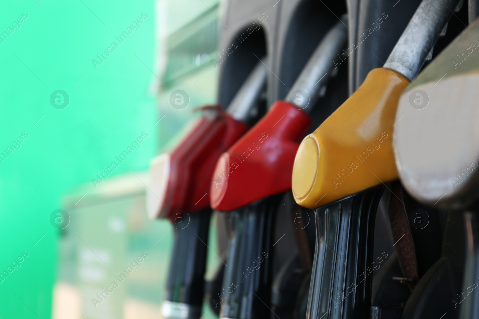 Photo of Closeup view of pump nozzles at gas station