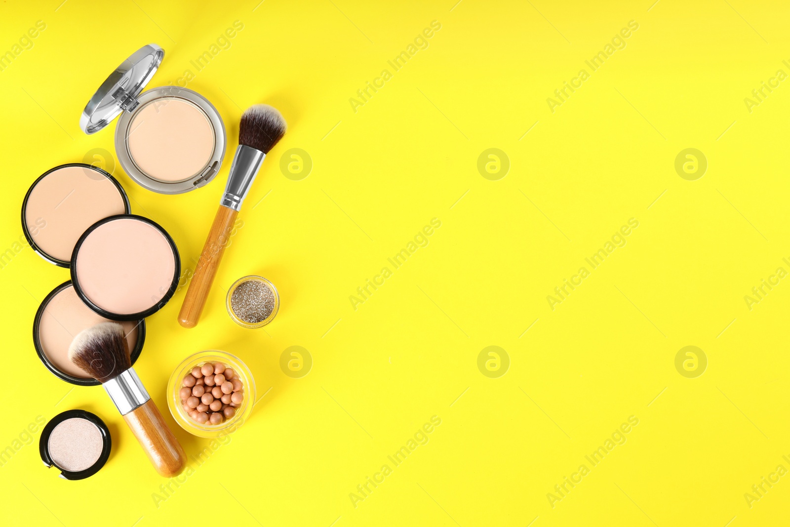 Photo of Flat lay composition with makeup brushes on yellow background, space for text