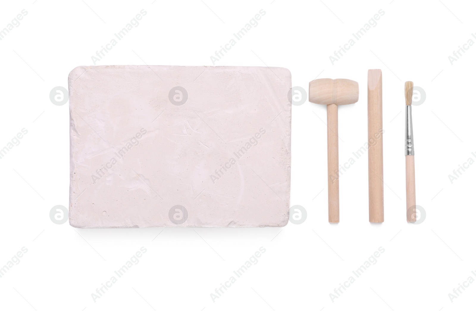 Photo of Educational toy for motor skills development. Excavation kit (plaster, digging tools and brush) isolated on white, top view