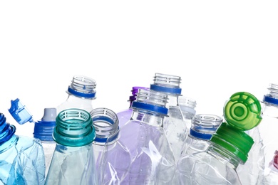 Photo of Pile of crumpled bottles on white background, closeup. Plastic recycling